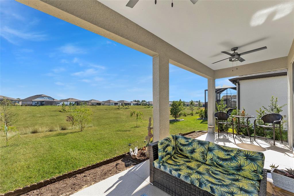 6034 Southwest 86th Circle Ocala, FL 34481 - Photo 41 of 59 a view of a chairs and table in patio with a yard