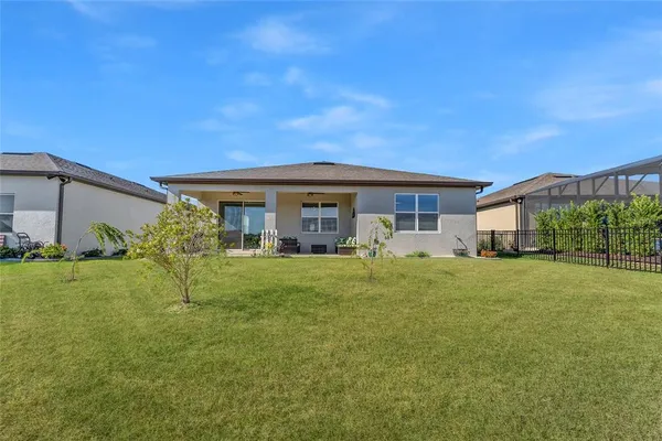 an aerial view of a residential houses with outdoor space