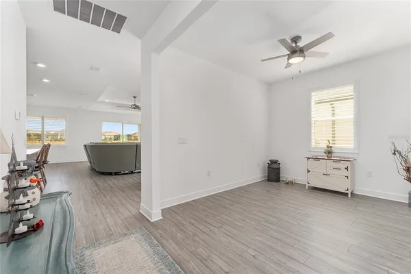 a dining room with furniture and wooden floor