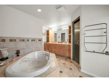 a bedroom with two beds and a lamp