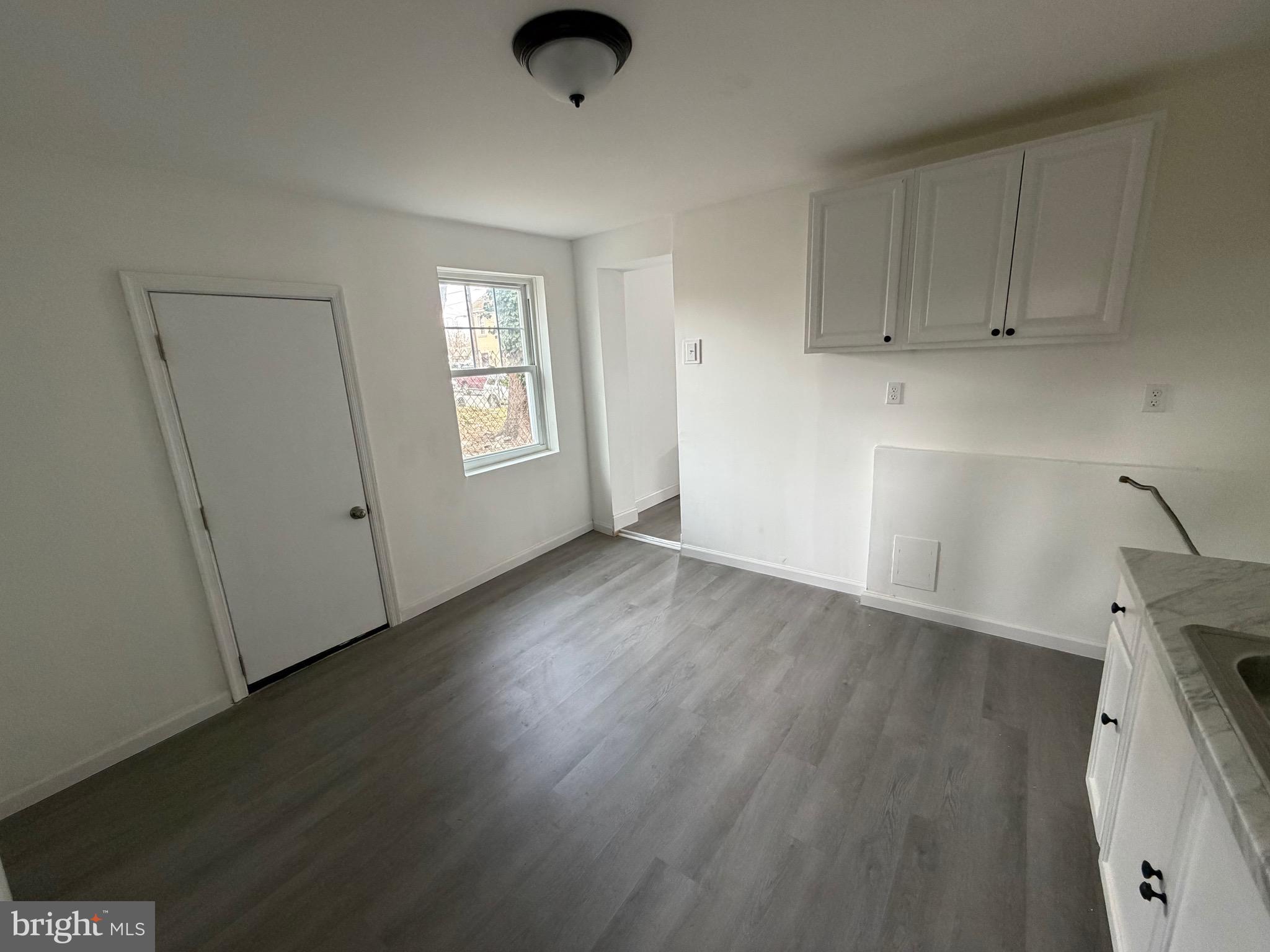 4148 Orchard Street Philadelphia, PA 19124 - Photo 11 of 25 a view of an empty room with a window and wooden floor