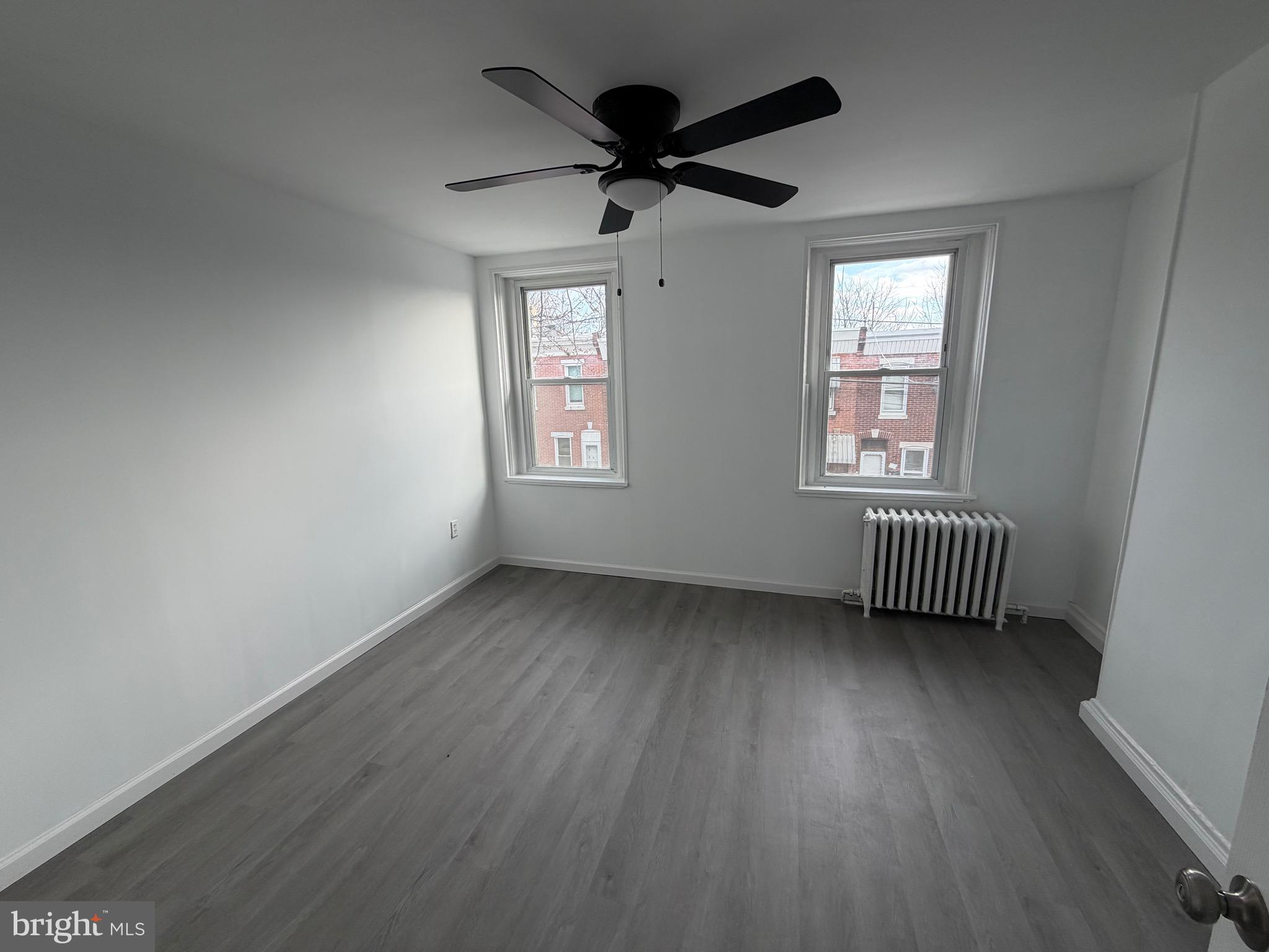 4148 Orchard Street Philadelphia, PA 19124 - Photo 12 of 25 a view of an empty room with a window and wooden floor