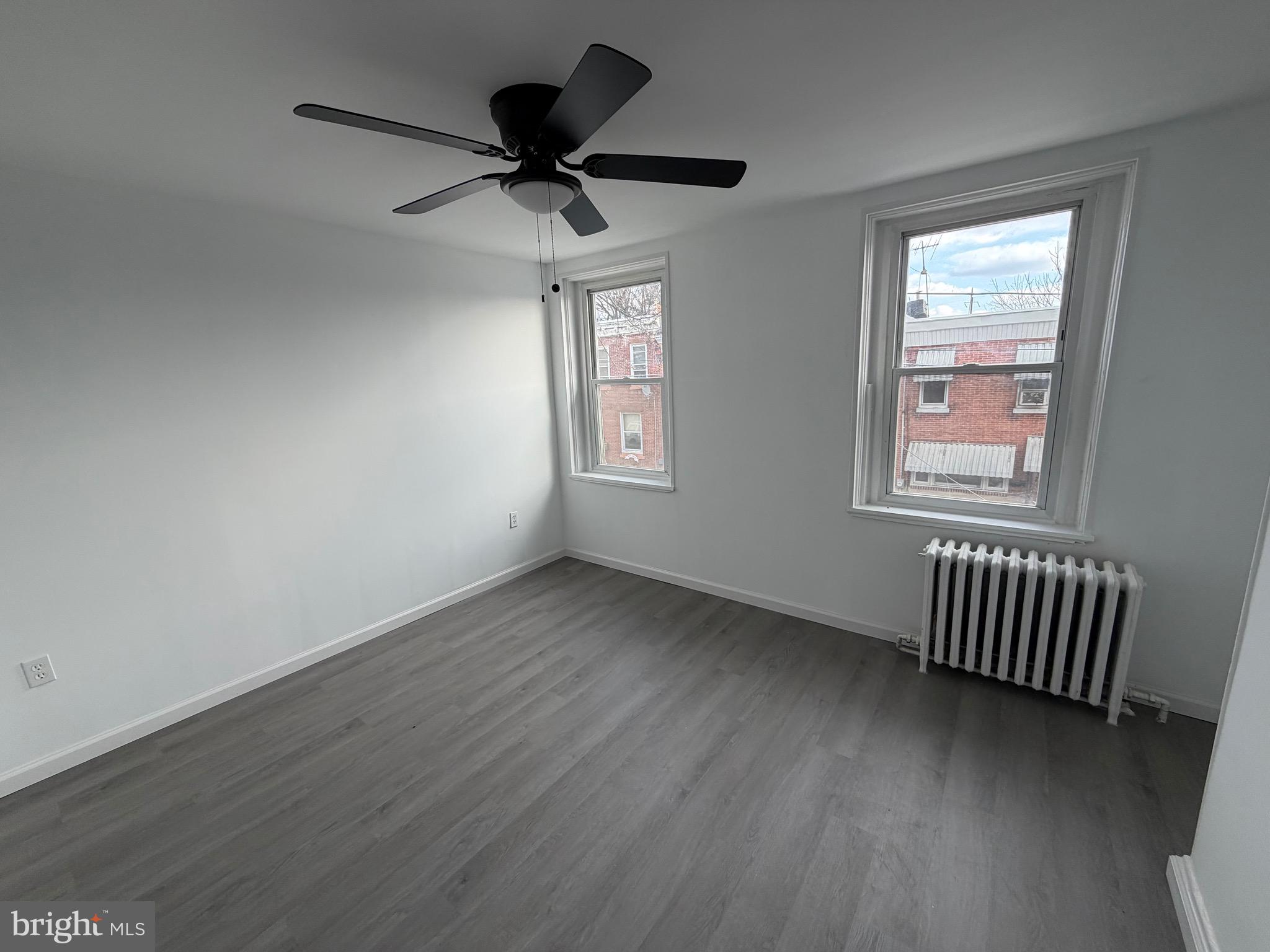 4148 Orchard Street Philadelphia, PA 19124 - Photo 13 of 25 a view of an empty room with a window and wooden floor