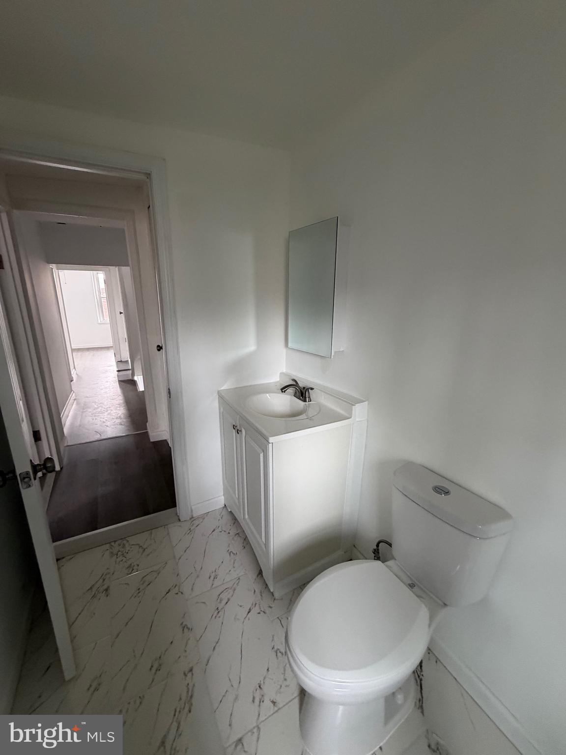 4148 Orchard Street Philadelphia, PA 19124 - Photo 20 of 25 a bathroom with a toilet a sink and mirror