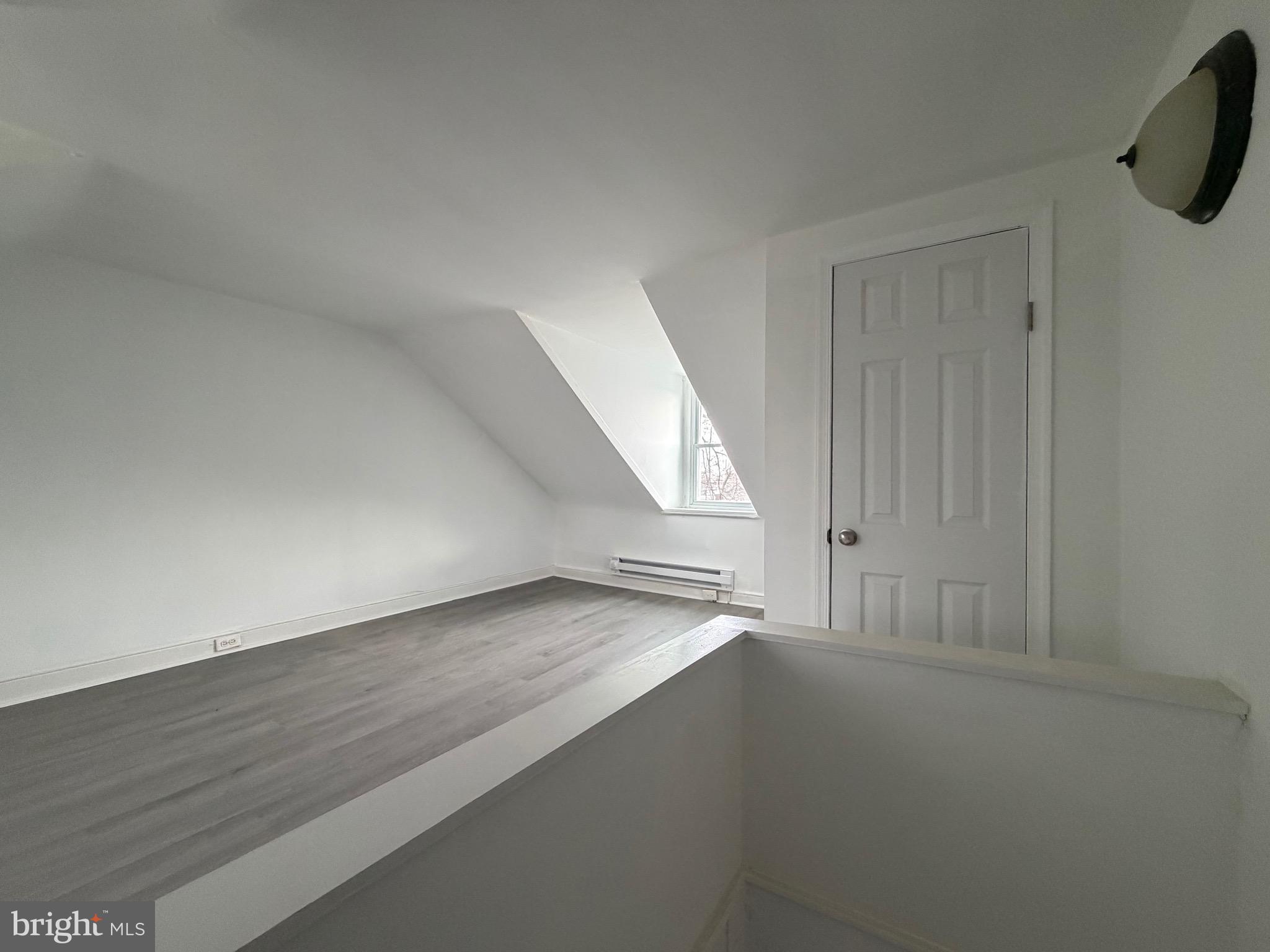 4148 Orchard Street Philadelphia, PA 19124 - Photo 22 of 25 an empty room with wooden floor and cabinet