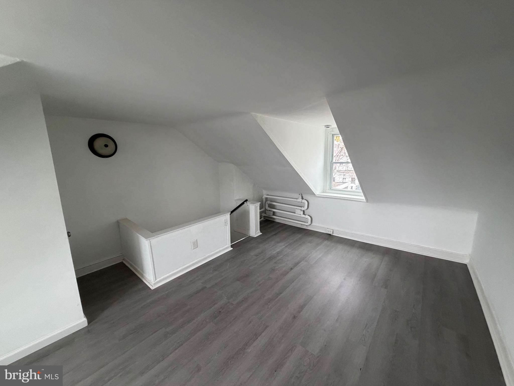 4148 Orchard Street Philadelphia, PA 19124 - Photo 24 of 25 an empty room with wooden floor and windows