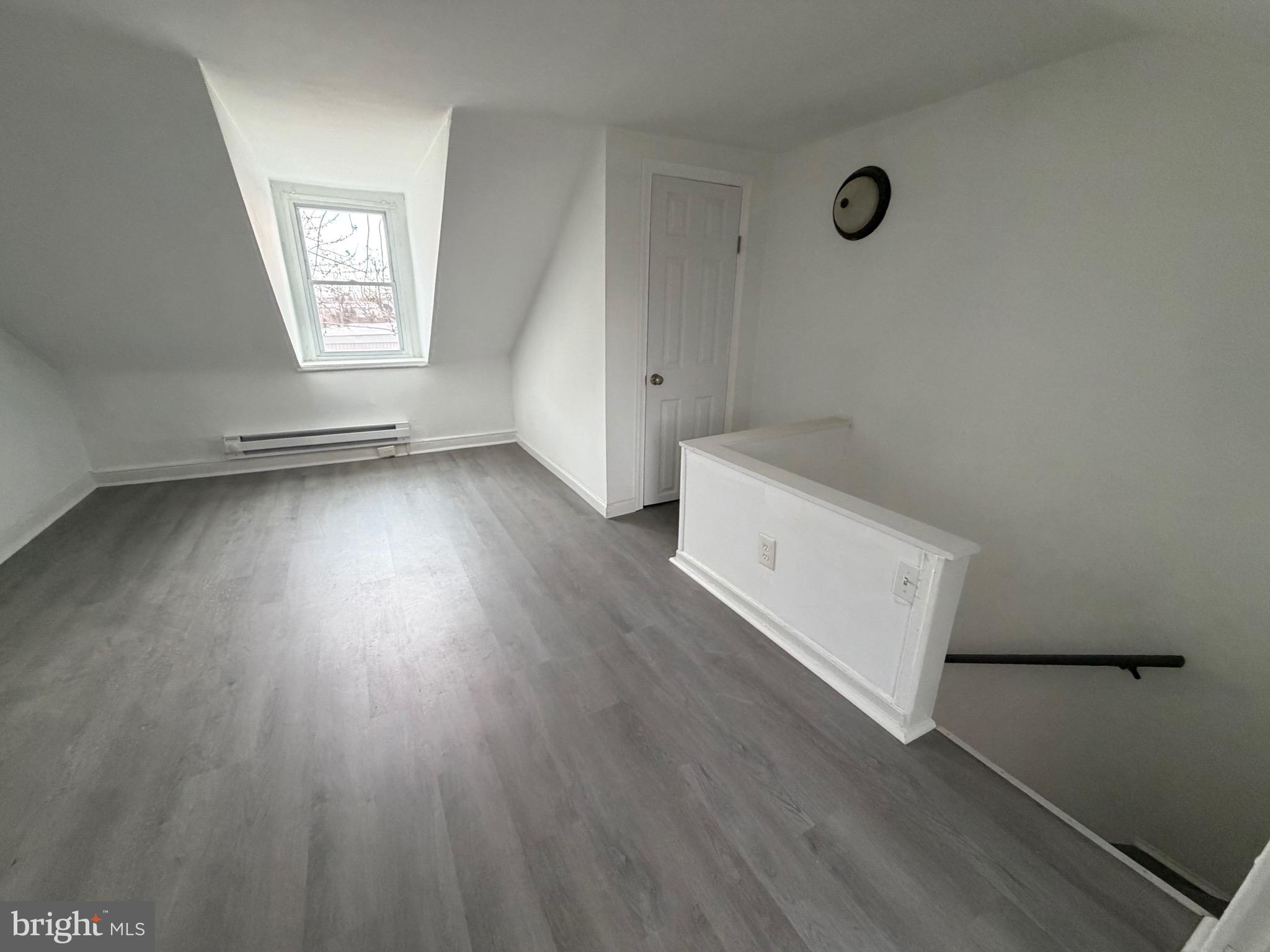 4148 Orchard Street Philadelphia, PA 19124 - Photo 25 of 25 an empty room with wooden floor and windows