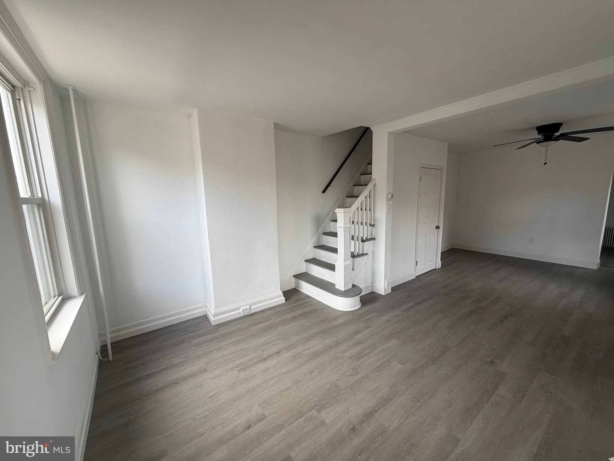 4148 Orchard Street Philadelphia, PA 19124 - Photo 4 of 25 an empty room with wooden floor and windows