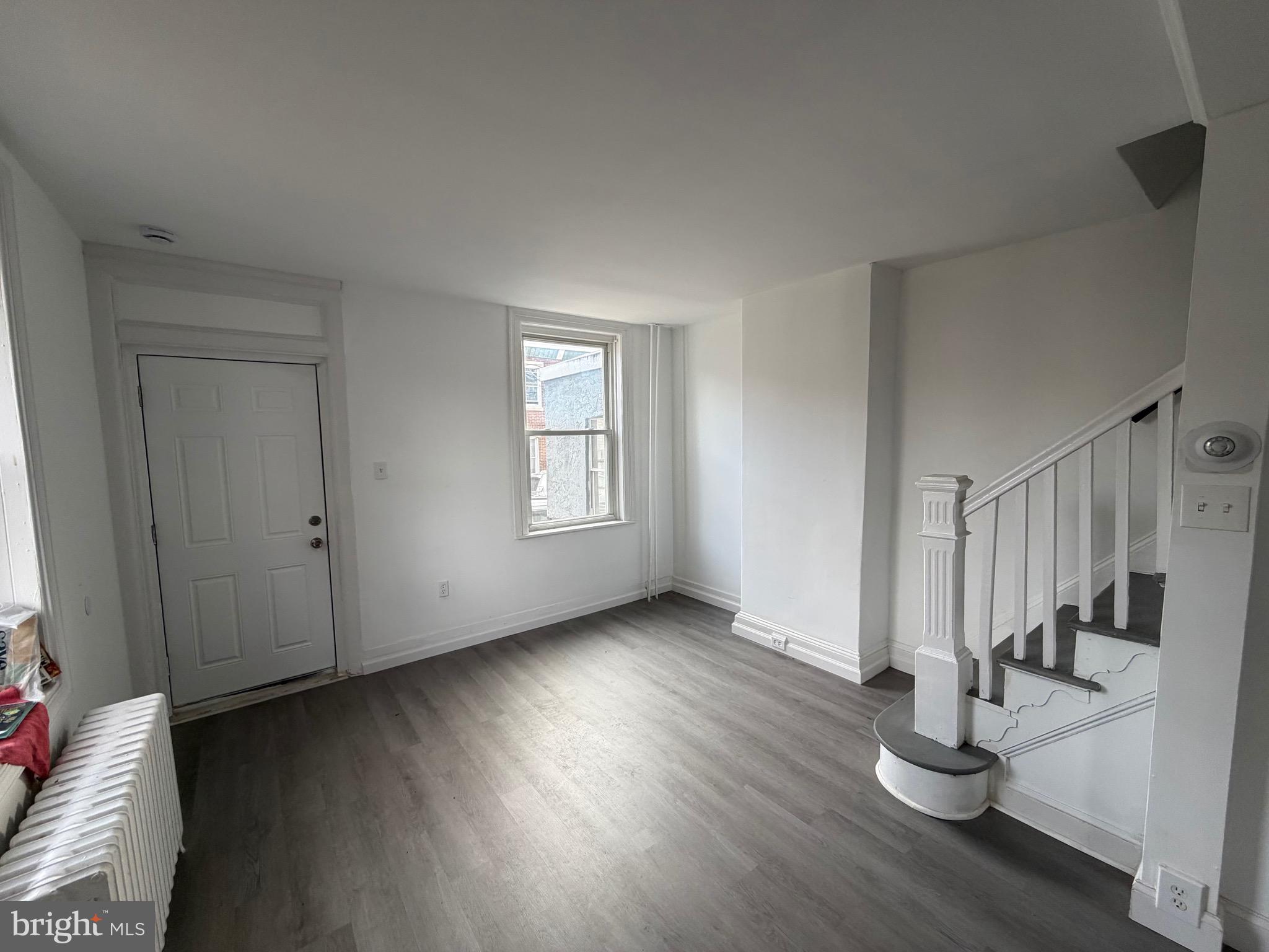 4148 Orchard Street Philadelphia, PA 19124 - Photo 5 of 25 an empty room with wooden floor and windows