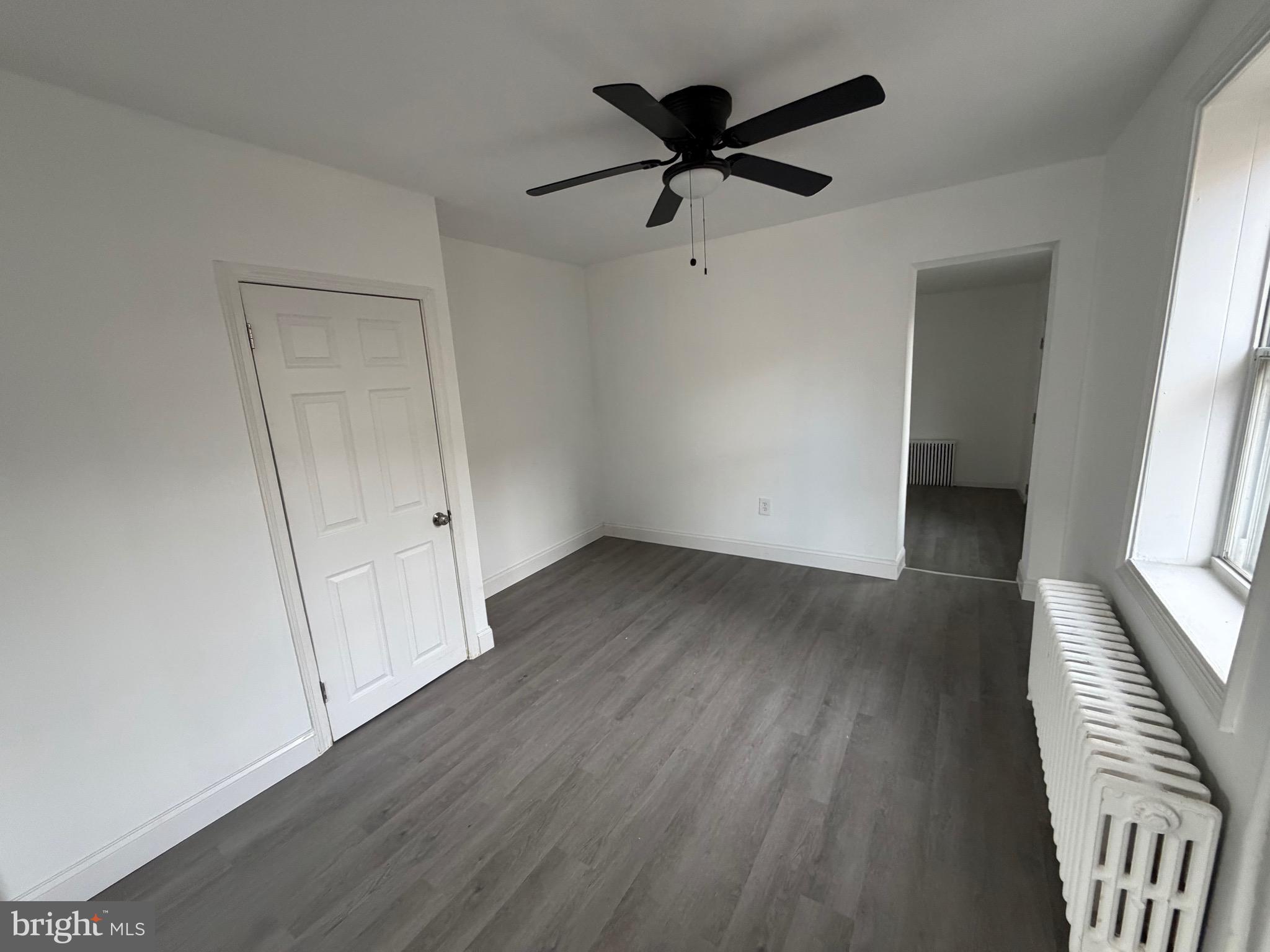 4148 Orchard Street Philadelphia, PA 19124 - Photo 6 of 25 an empty room with wooden floor and windows
