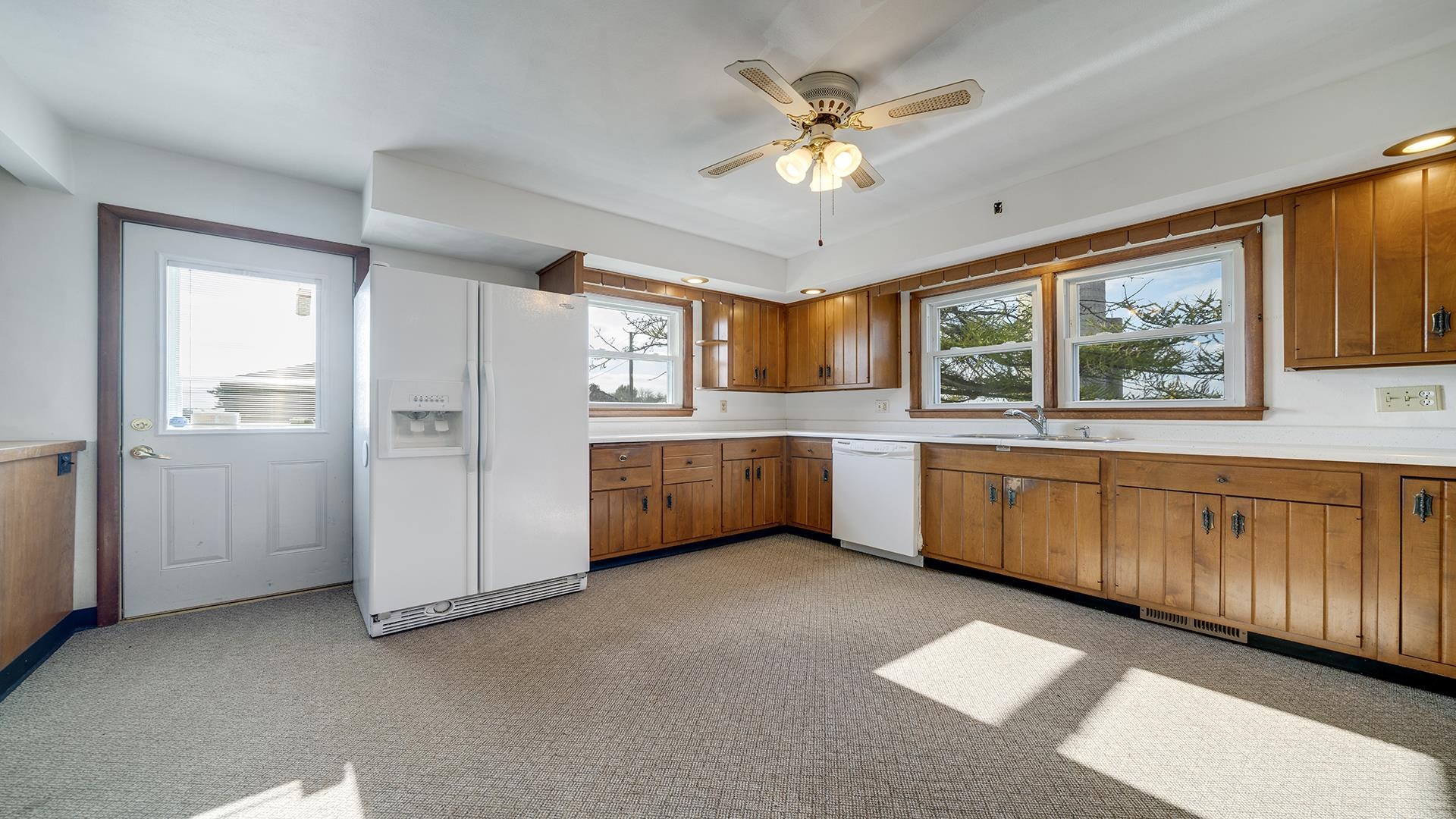 4303 Kendall Road Winnebago, IL 61088 - Photo 9 of 36 a view of a kitchen with a sink cabinet and a view of kitchen with wooden floor