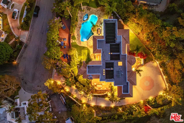 a view of a house with swimming pool and sitting area