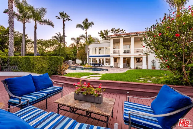 a large bedroom with a bed and wooden floor