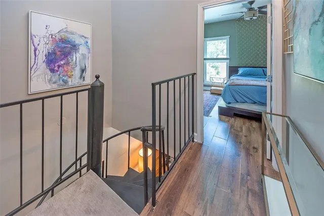 a view of a hallway with wooden floor and staircase
