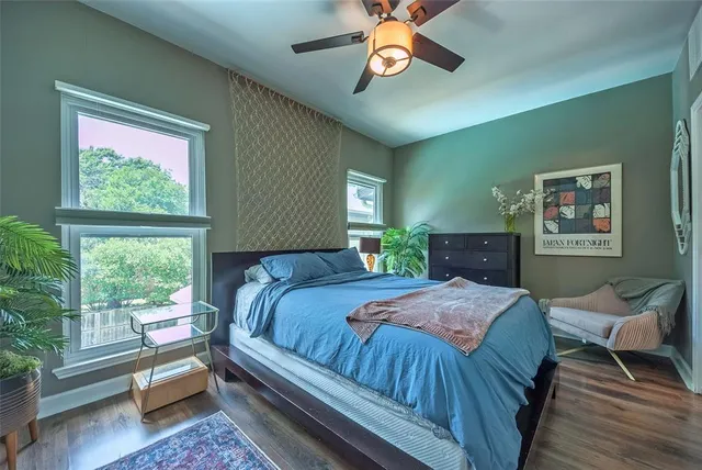 a bedroom with a bed and a large window