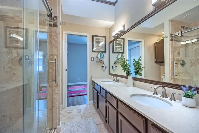 a bathroom with a double vanity sink and mirror