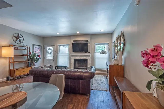 a living room with furniture a fireplace and a flat screen tv