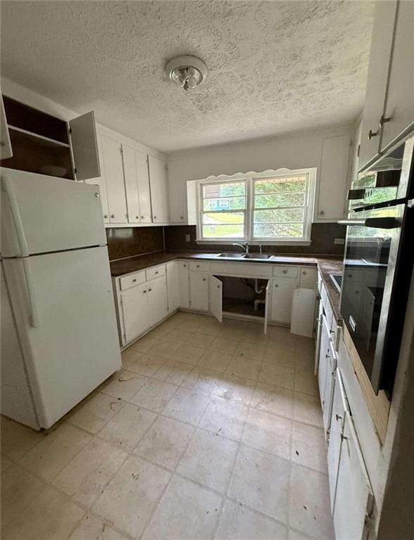 7205 Lakeview Drive Southwest Covington, GA 30014 - Photo 9 of 18 a kitchen with a sink a stove a refrigerator and cabinets