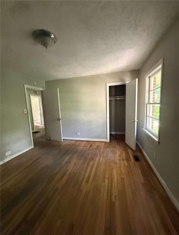 7205 Lakeview Drive Southwest Covington, GA 30014 - Photo 10 of 18 an empty room with wooden floor and windows