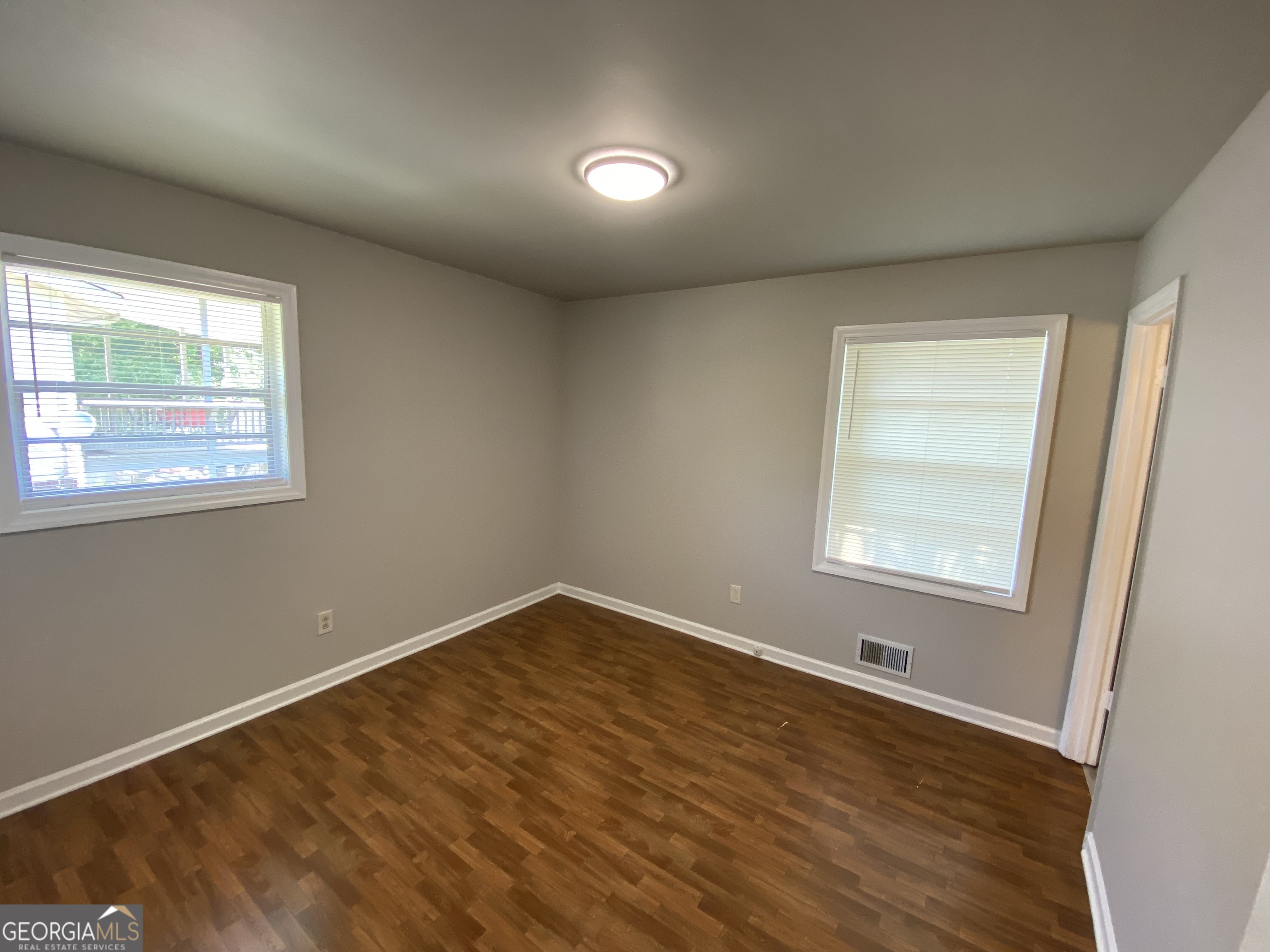 6092 Prestige Valley Road Morrow, GA 30260 - Photo 4 of 11 an empty room with wooden floor and windows