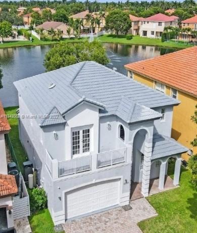an aerial view of a house with outdoor space lake view and lake view