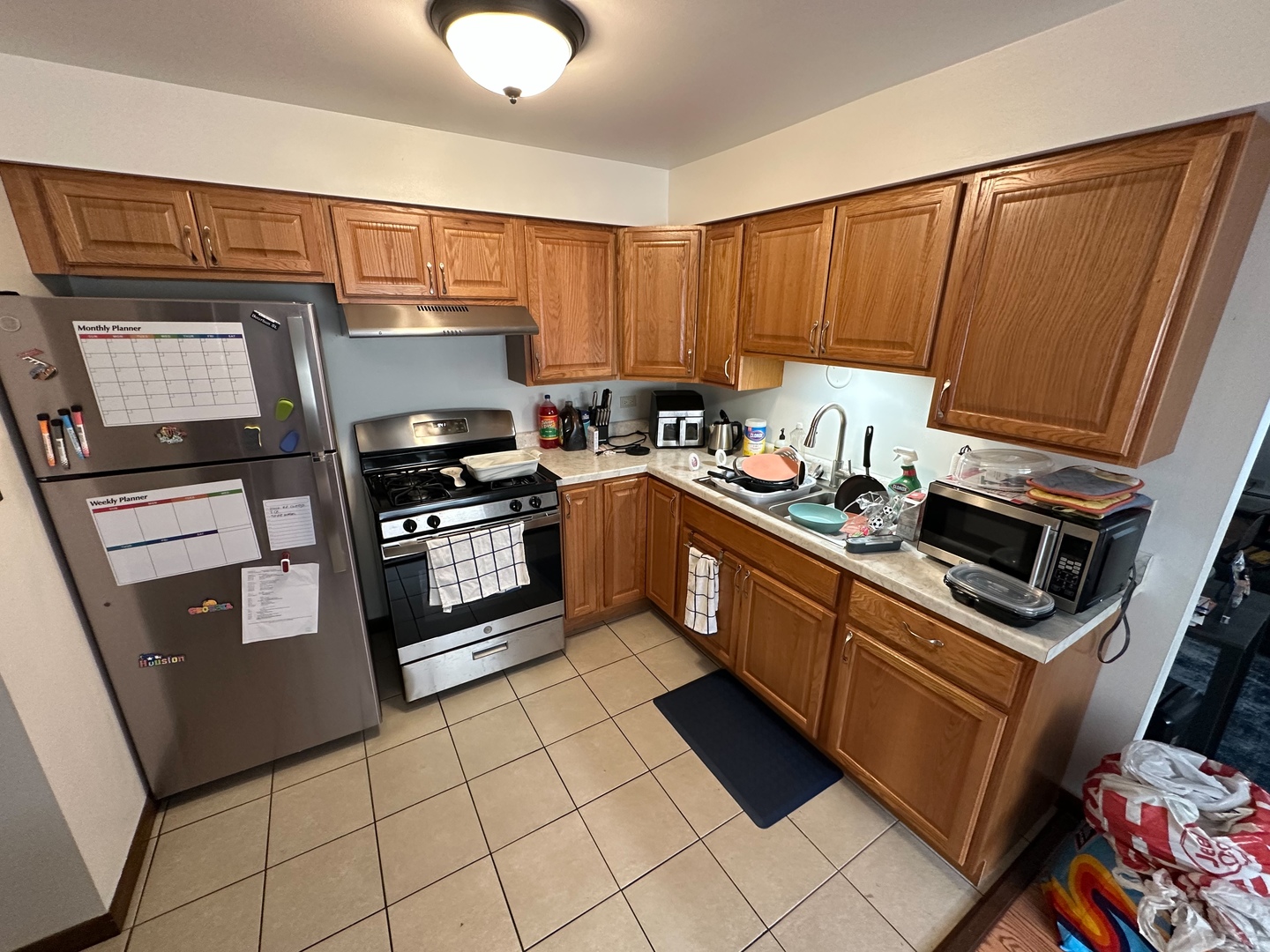 2121 176th Place Lansing, IL 60438 - Photo 8 of 26 a kitchen with stainless steel appliances granite countertop a stove a sink and a microwave