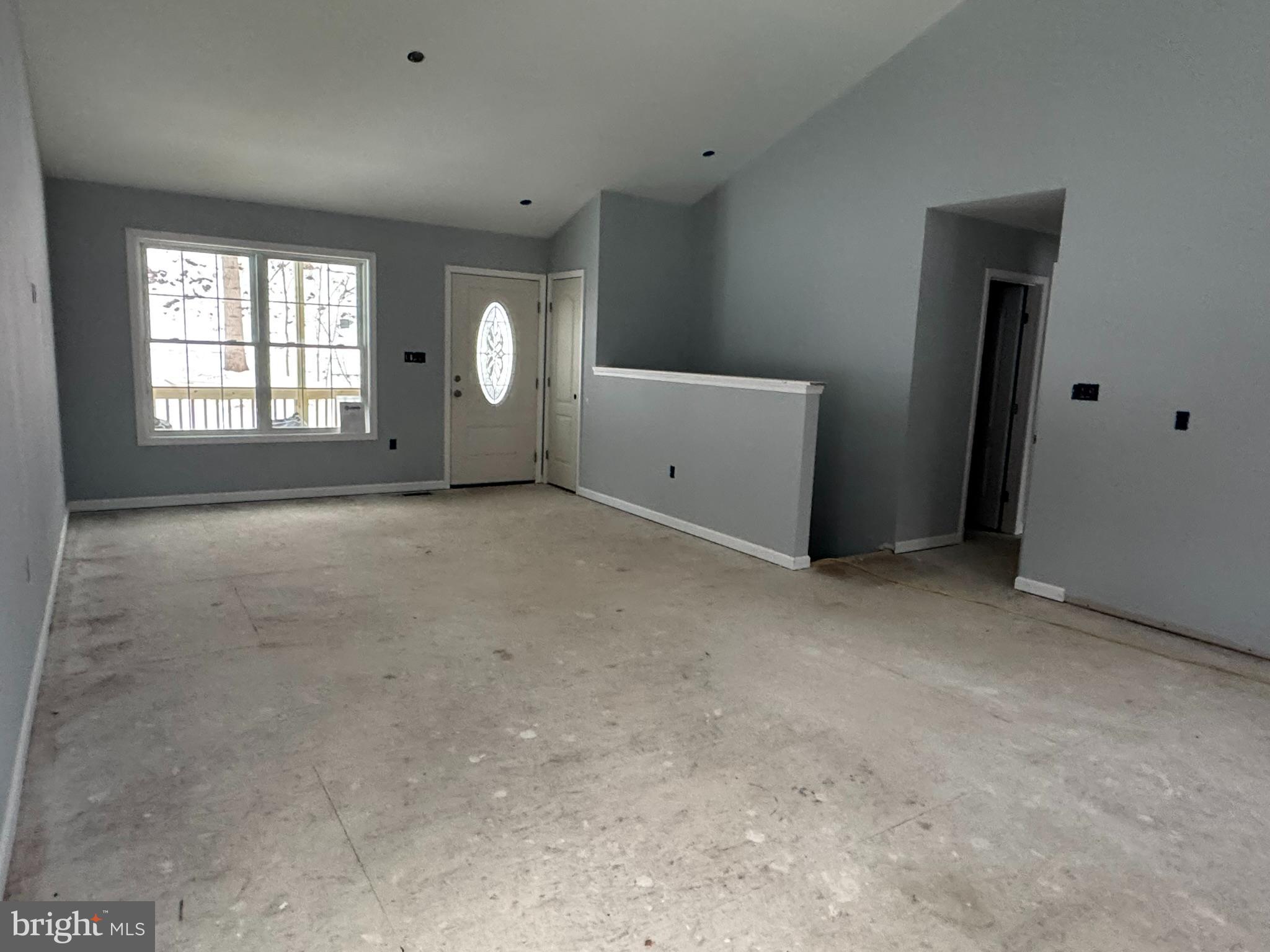 88 Thompson Mill Road Front Royal, VA 22630 - Photo 12 of 59 a view of an empty room with a window and a kitchen