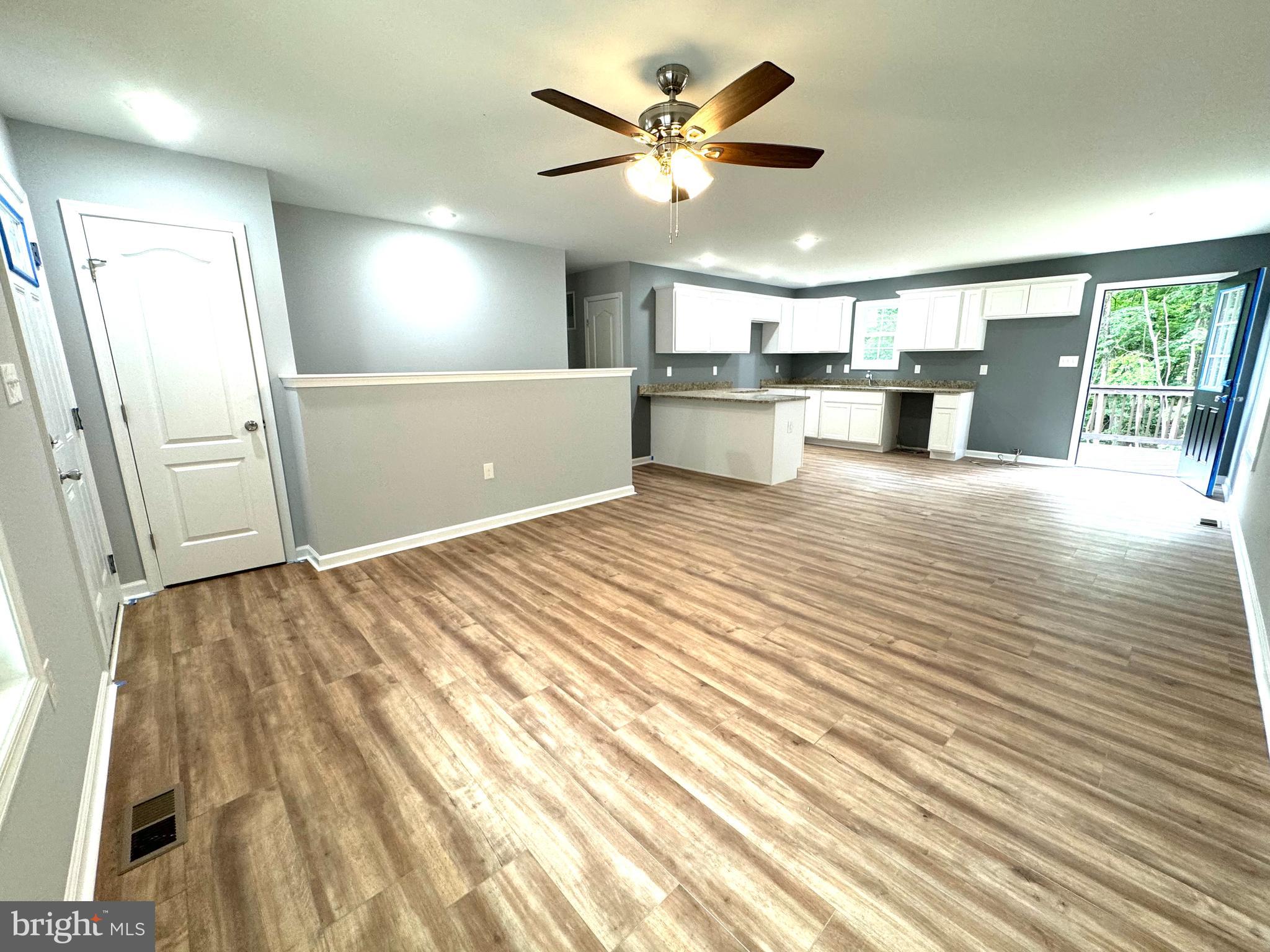 88 Thompson Mill Road Front Royal, VA 22630 - Photo 27 of 59 a view of a kitchen with wooden floor and a ceiling fan