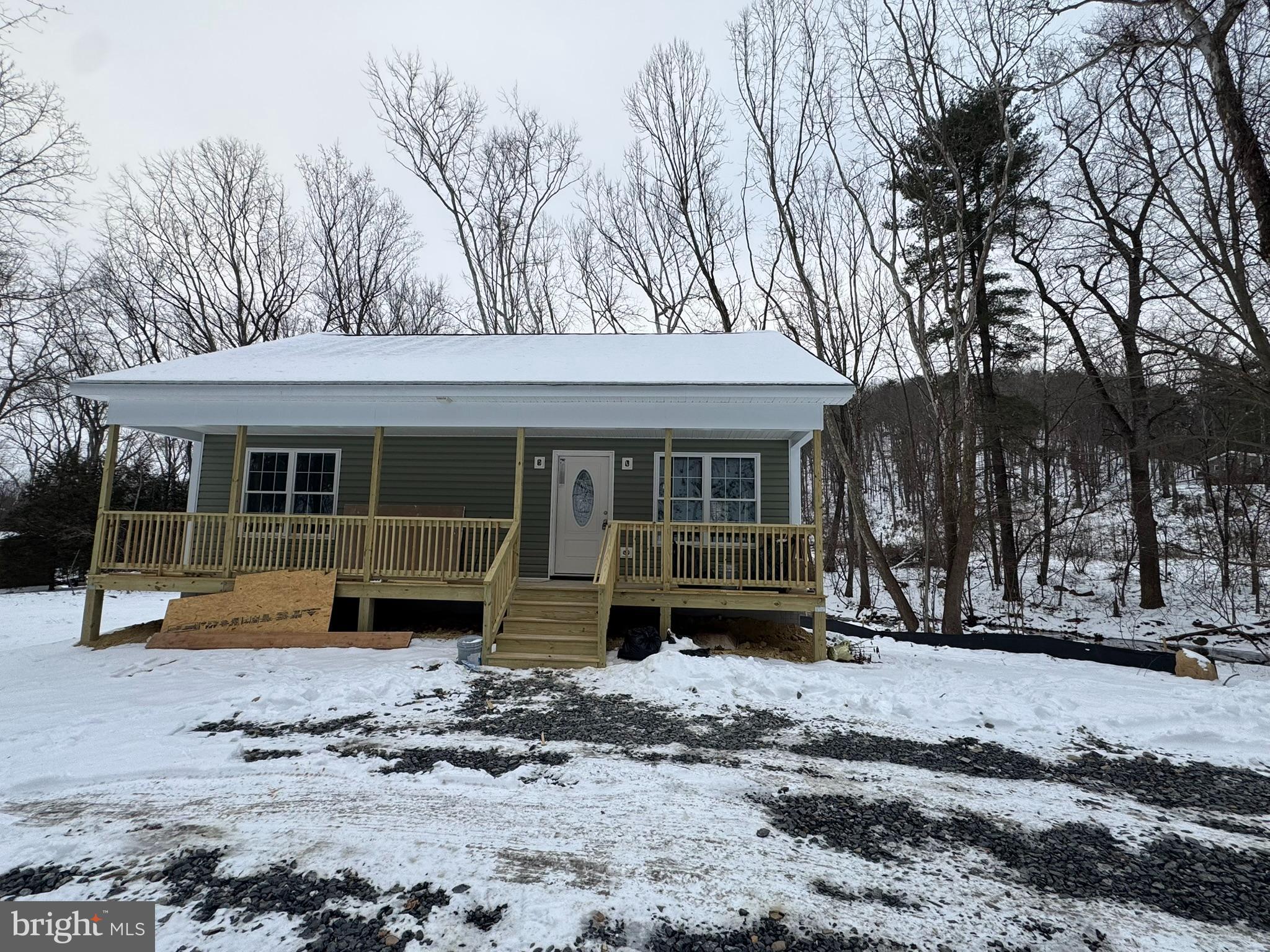 88 Thompson Mill Road Front Royal, VA 22630 - Photo 3 of 59 a front view of a house with a yard covered in snow