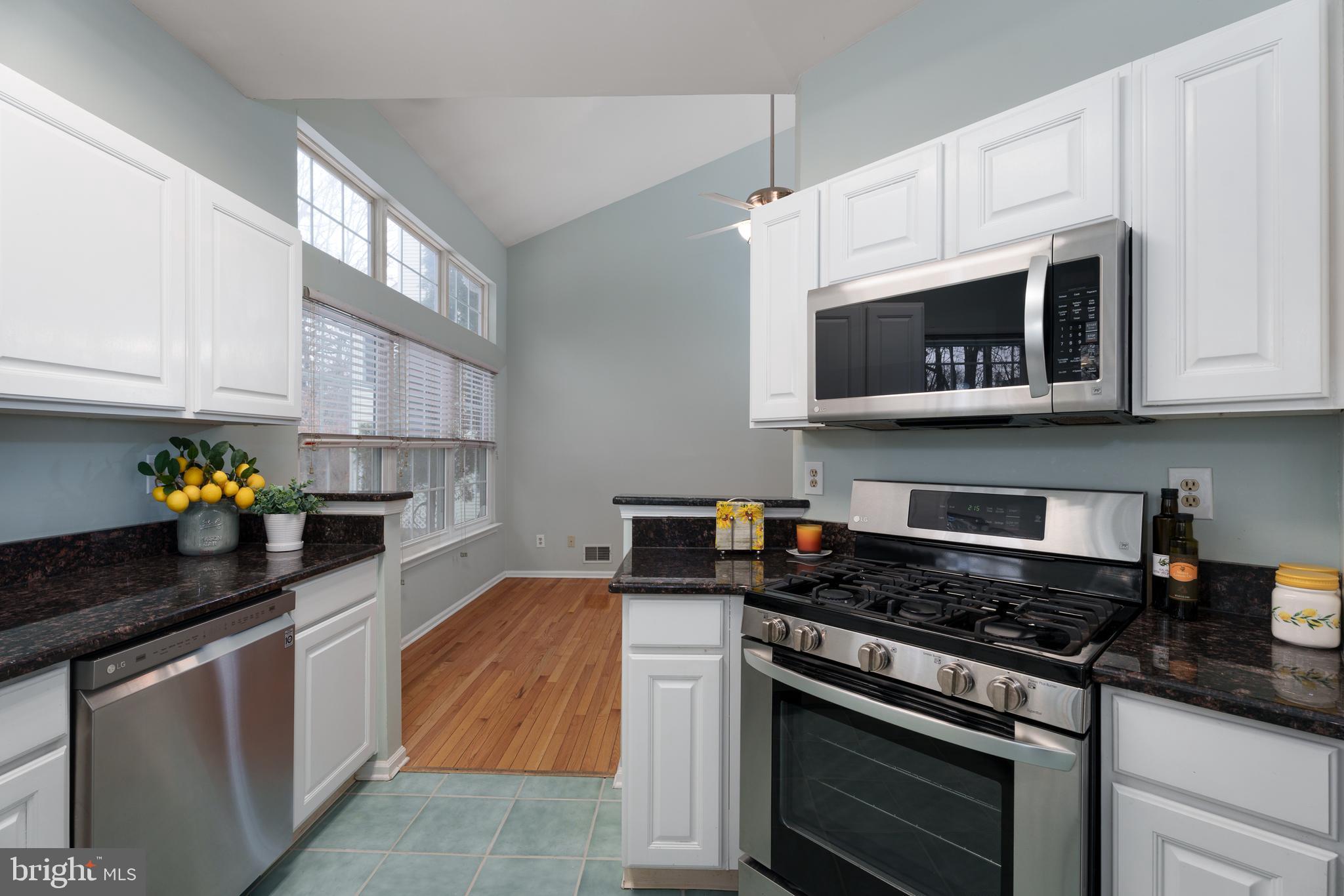 19 Rider Terrace Princeton, NJ 08540 - Photo 10 of 28 a kitchen with stainless steel appliances granite countertop white cabinets and black stove top oven with granite countertops