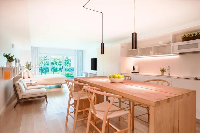 a view of a kitchen area with furniture and wooden floor