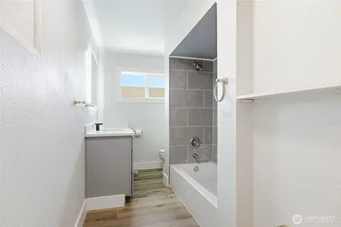 a bathroom with a tub sink and mirror