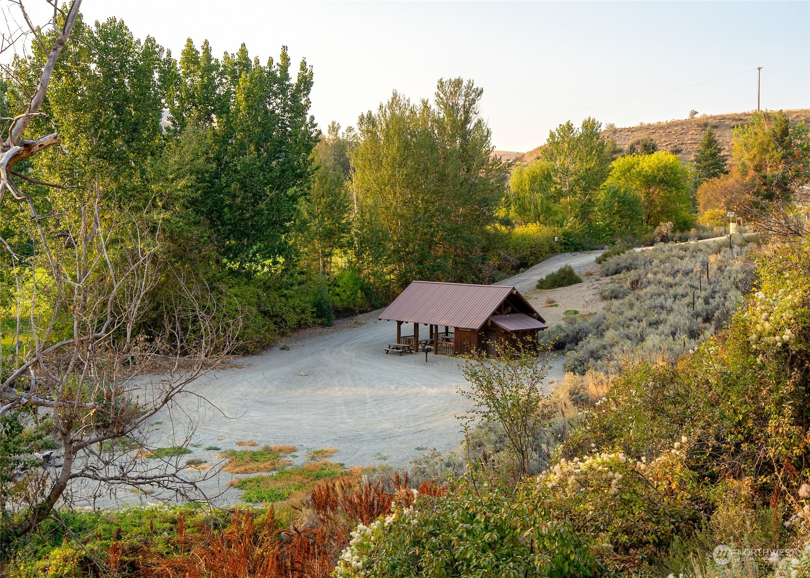 0 Hannah Road, Unit 19 Pateros, WA 98846 - Photo 21 of 25 a wooden bench sitting in the middle of a field