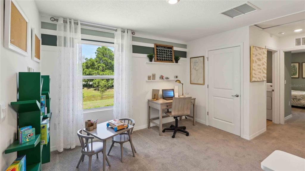 24430 Northwest 10th Road Newberry, FL 32669 - Photo 14 of 24 a view of a workspace with furniture and a window