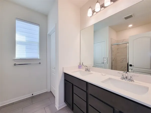 a bathroom with 2 sink and a mirror