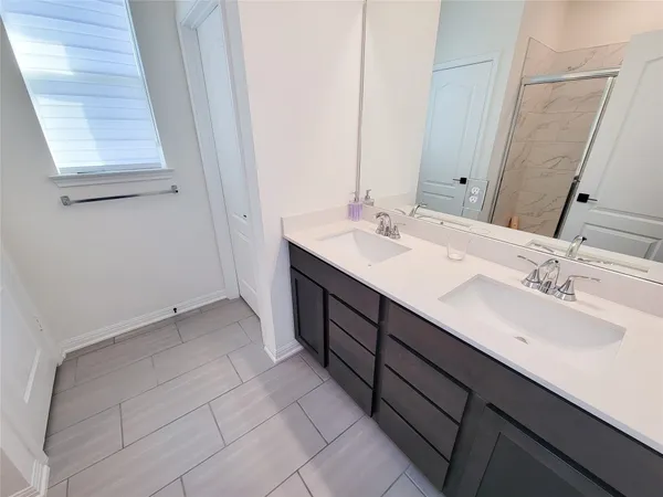 a spacious bathroom with a shower and a sink