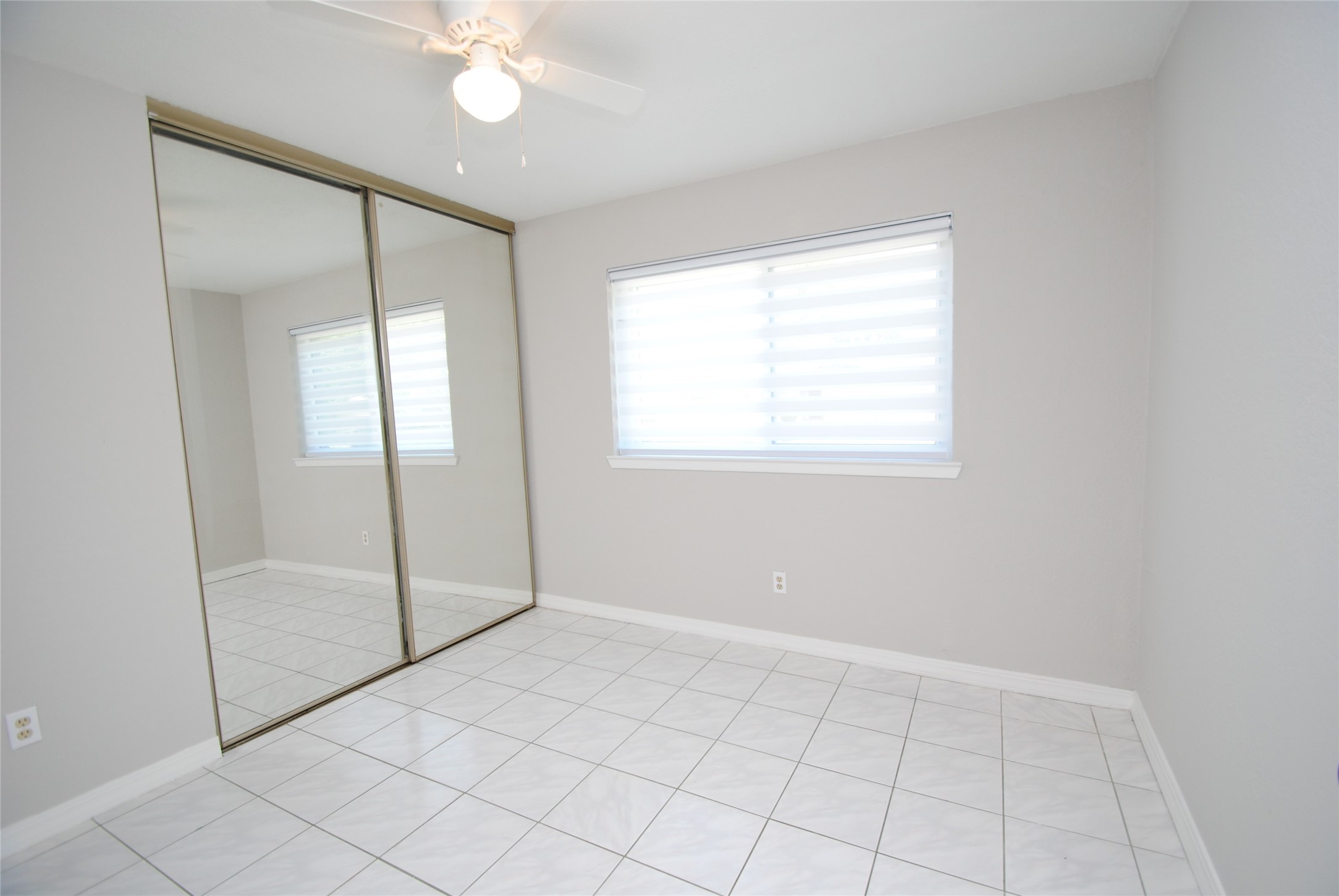 22831 John Rolfe Lane Katy, TX 77449 - Photo 30 of 34 a view of an empty room with window and chandelier fan