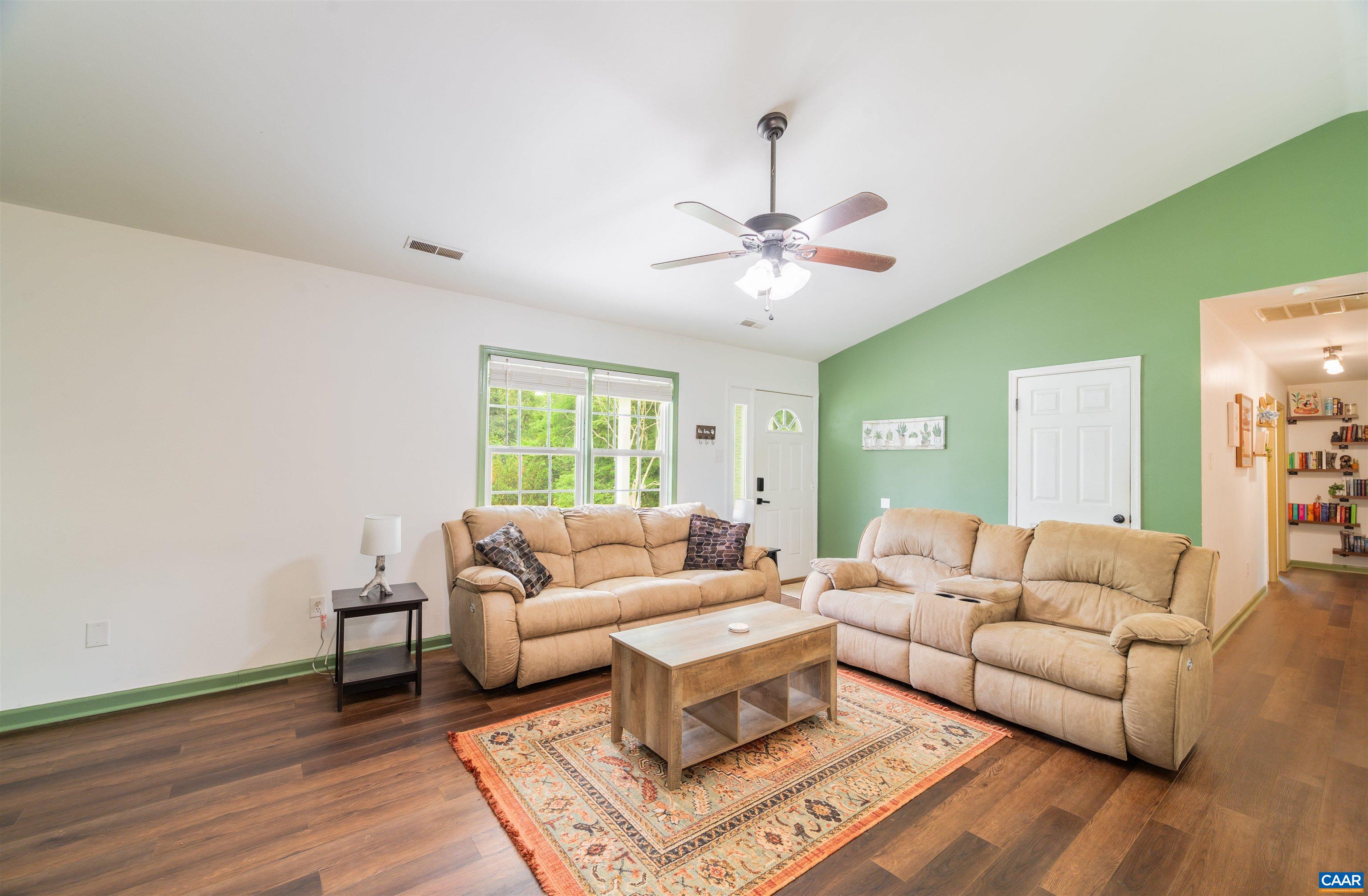 71 Blue Bell Road Ruckersville, VA 22968 - Photo 12 of 28 a living room with furniture and a chandelier