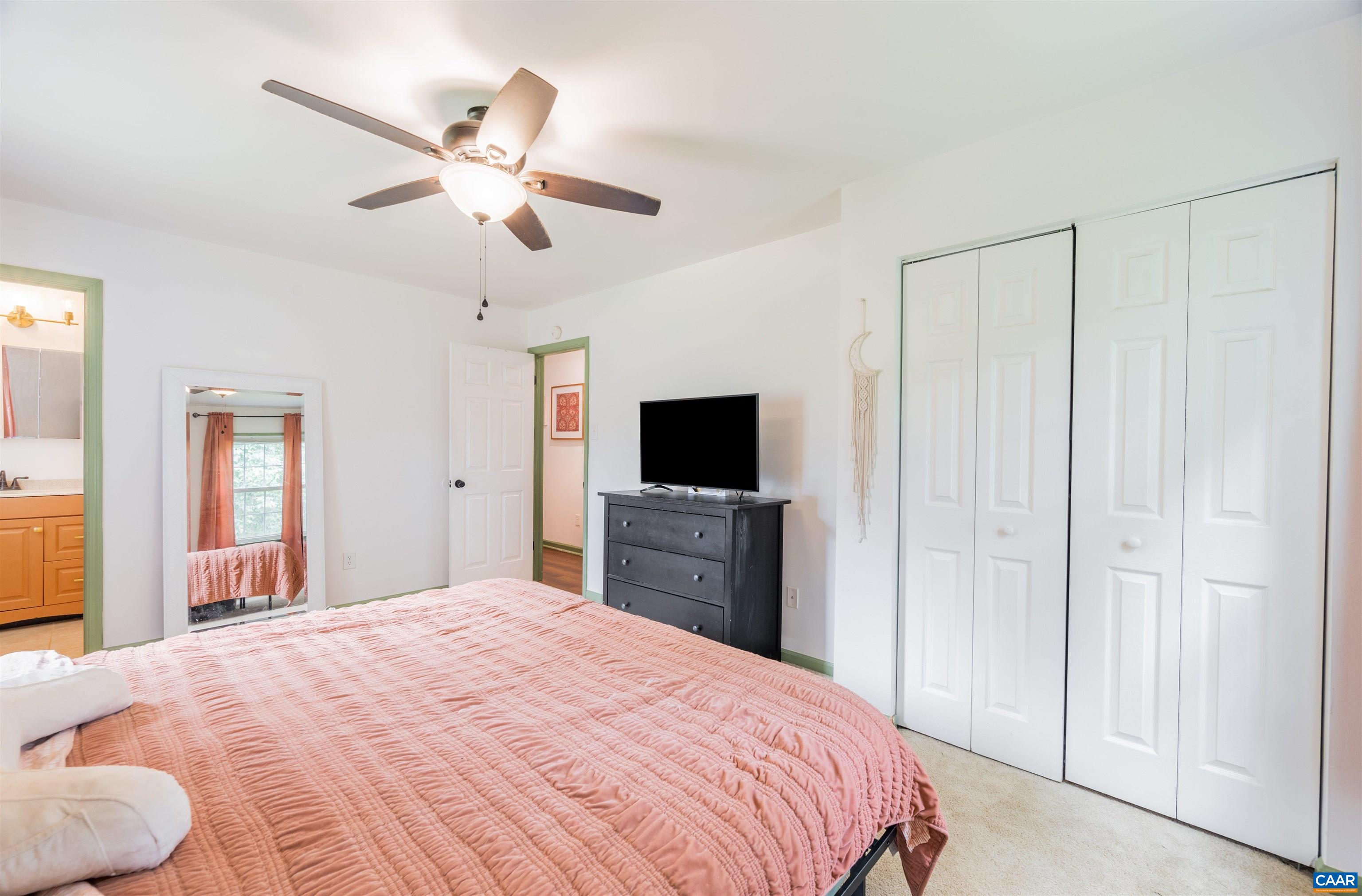 71 Blue Bell Road Ruckersville, VA 22968 - Photo 19 of 28 a bedroom with a bed and a chandelier