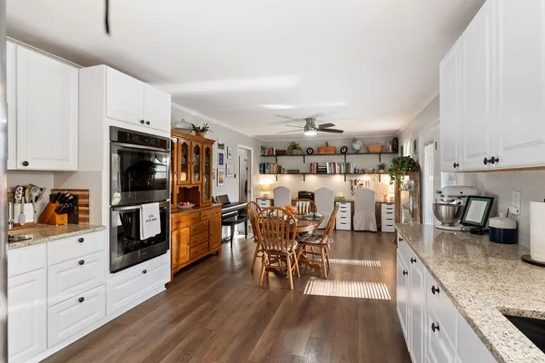 a kitchen with stainless steel appliances granite countertop a refrigerator and stove top oven