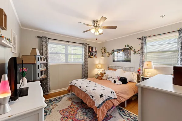 a bedroom with a bed and a window