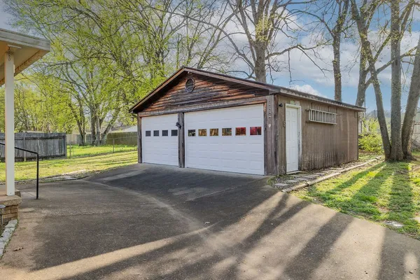 a view of a house with a yard and garage