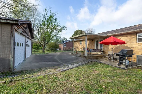 a view of a house with backyard and sitting area