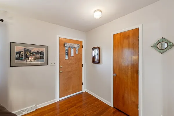a view of a bedroom with wooden floor and hallway