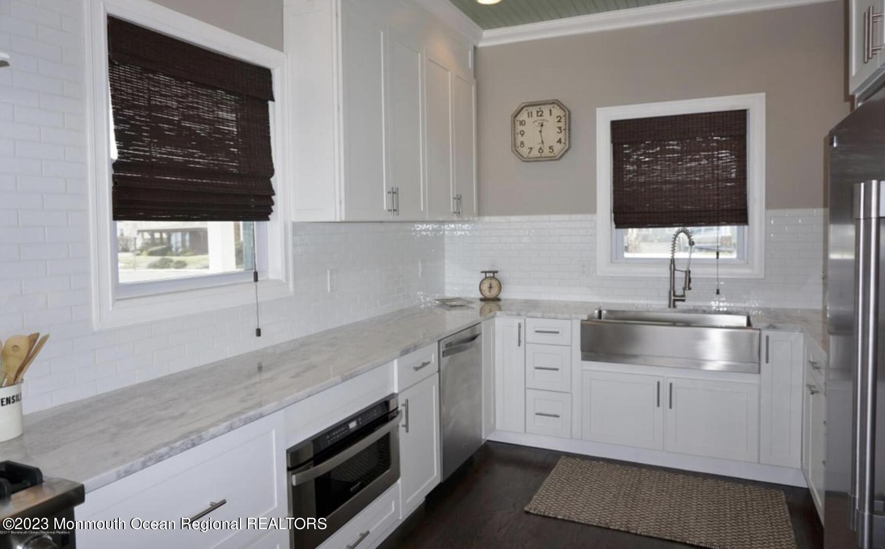 469 Ocean Avenue North, Unit WINTER Long Branch, NJ 07740 - Photo 14 of 47 a kitchen with a sink stove and cabinets