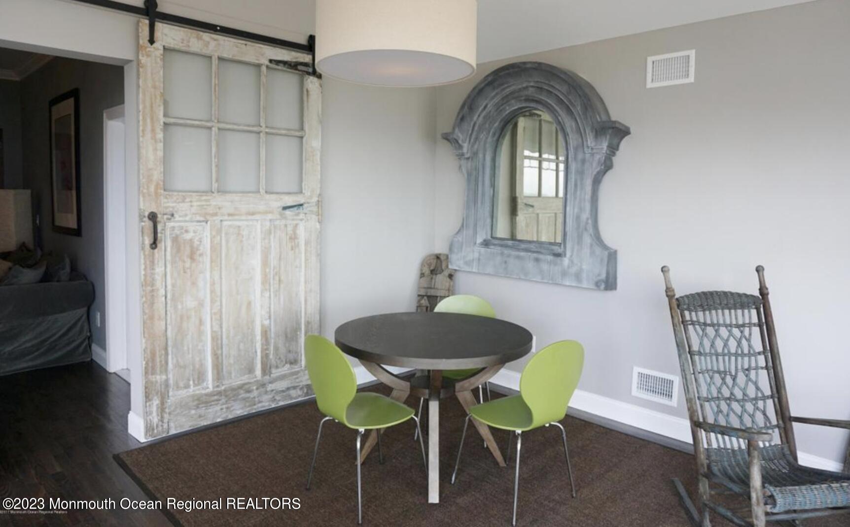 469 Ocean Avenue North, Unit WINTER Long Branch, NJ 07740 - Photo 15 of 47 a view of a dining room with furniture and wooden floor