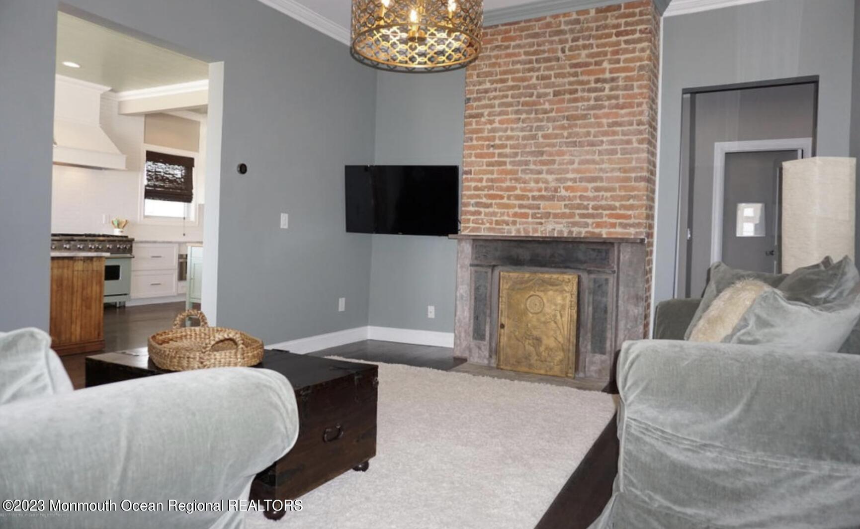 469 Ocean Avenue North, Unit WINTER Long Branch, NJ 07740 - Photo 17 of 47 a living room with furniture a fireplace and a flat screen tv