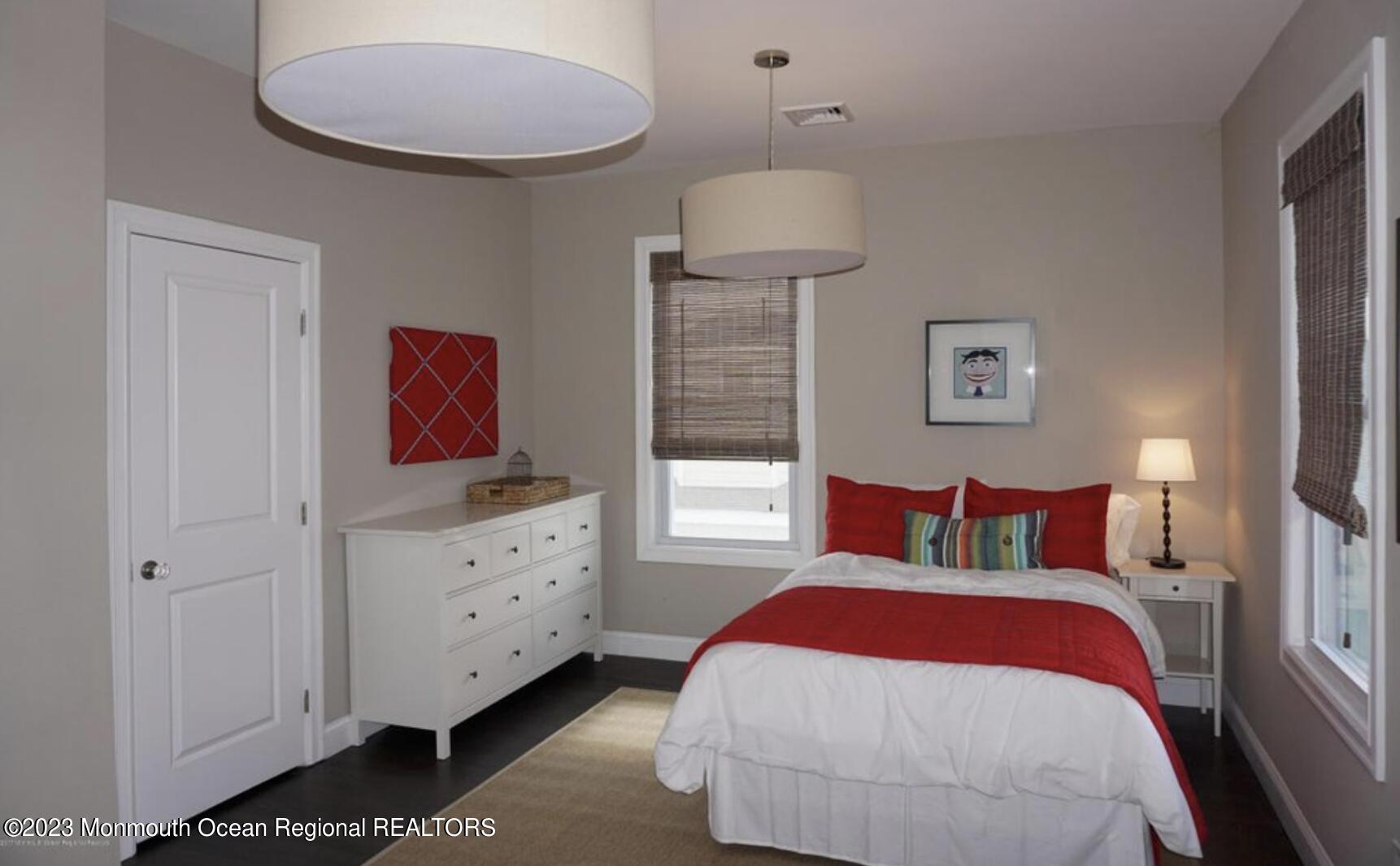 469 Ocean Avenue North, Unit WINTER Long Branch, NJ 07740 - Photo 22 of 47 a bedroom with a bed and a chandelier