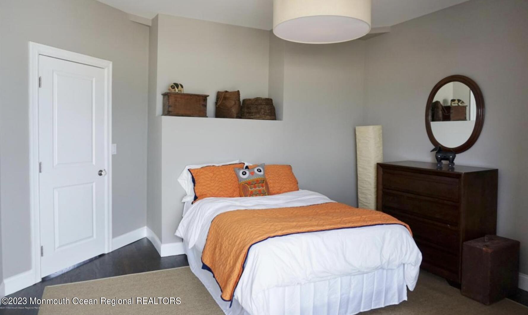 469 Ocean Avenue North, Unit WINTER Long Branch, NJ 07740 - Photo 23 of 47 a bedroom with a bed and a table in it