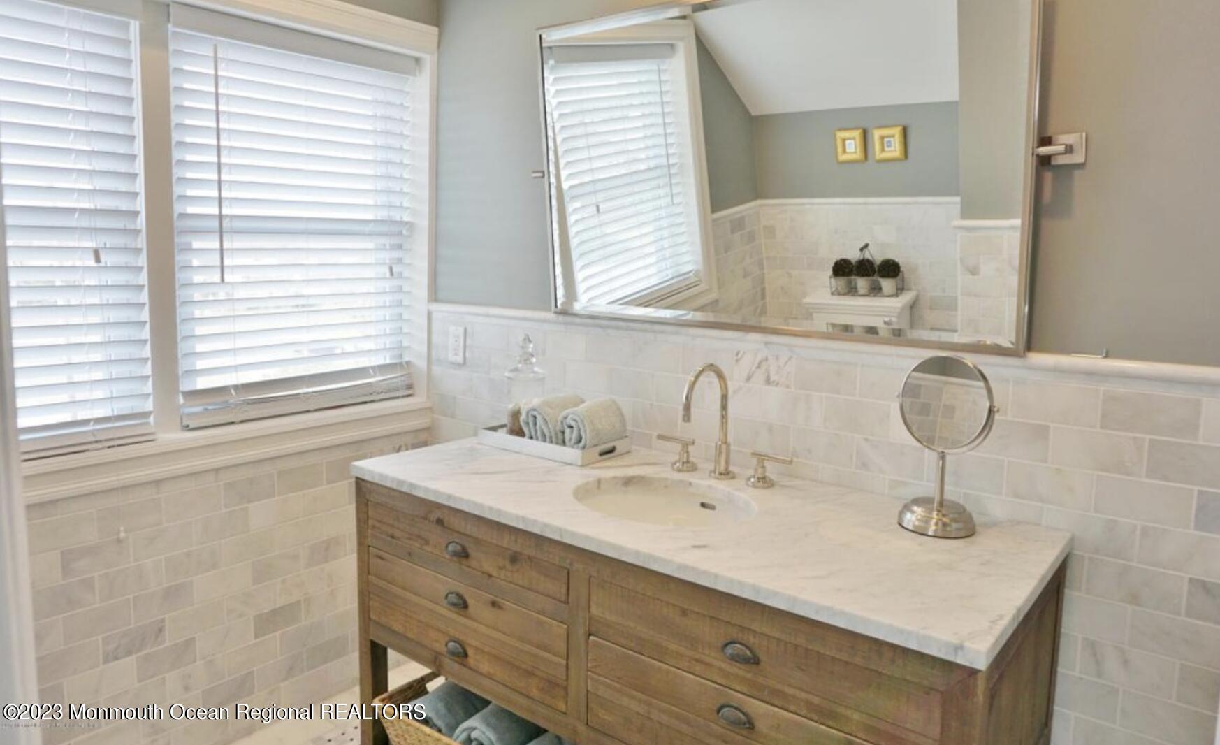 469 Ocean Avenue North, Unit WINTER Long Branch, NJ 07740 - Photo 31 of 47 a bathroom with a sink and a window